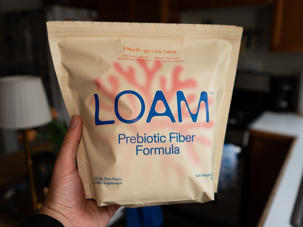 LOAM prebiotic fiber held in a kitchen